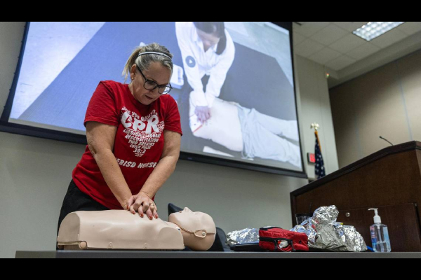 Person doing CPR on manikin