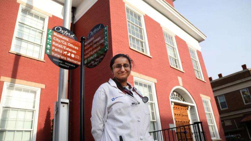 photo of woman standing infront of building