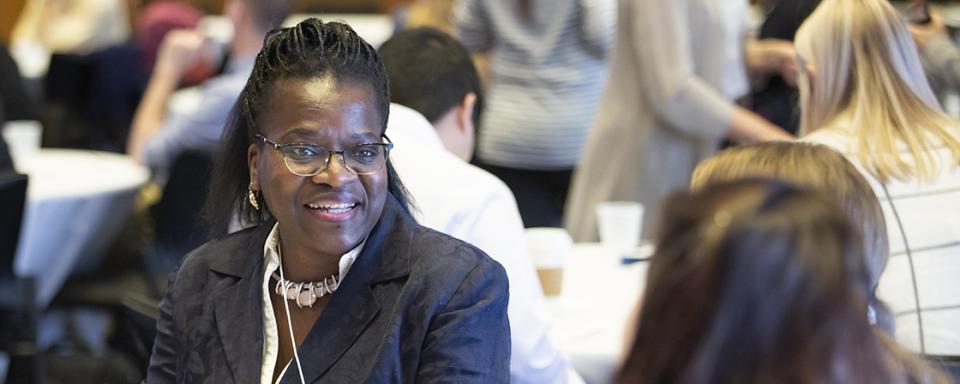 woman speaking to someone at a conference