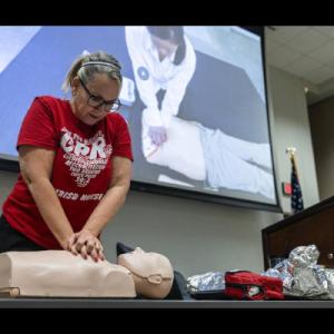 Person doing CPR on manikin