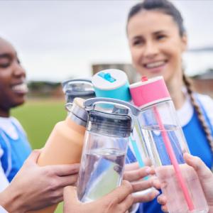 People clinking water bottles together